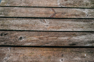 Obraz premium Old wooden brown background. Texture. Place for text. close up. part of the wooden bridge.