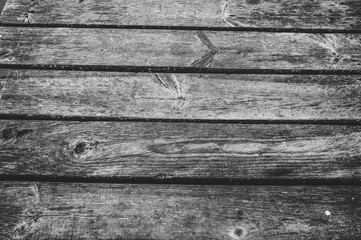 Old wooden brown background. Texture. Place for text. close up. part of the wooden bridge. black and white photo