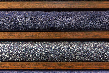 samples of multi-colored carpets on the shelves