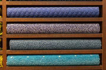samples of multi-colored carpets on the shelves