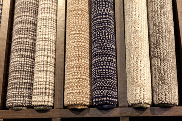 samples of multi-colored carpets on the shelves
