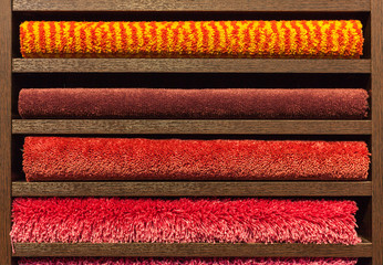 samples of multi-colored carpets on the shelves