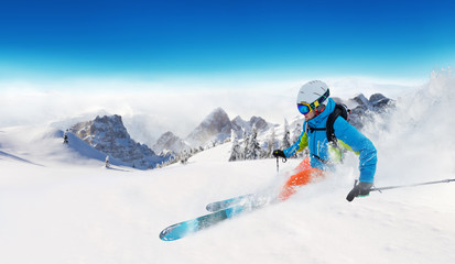 Fototapeta na wymiar Young man skiing in Alps
