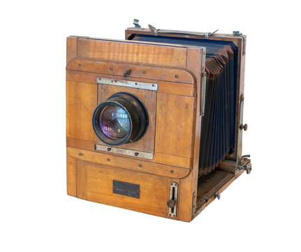 Old vintage wooden camera with lens