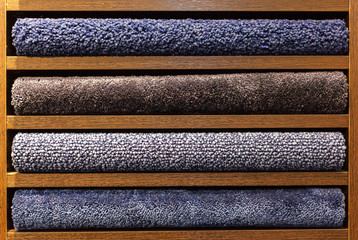 samples of multi-colored carpets on the shelves