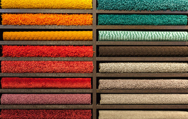 samples of multi-colored carpets on the shelves