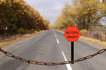 The road is blocked by a chain. Road sign with text "No deal brexit". Digital composition.