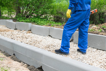 worker feet stand on unfinished road, bottom view