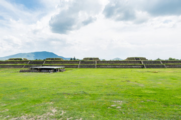 Obraz premium Ruins of the architecturally significant Mesoamerican pyramids and green grassland located at at Teotihuacan, an ancient Mesoamerican city located in a sub-valley of the Valley of Mexico