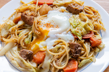 Pork Curry spaghetti  on wooden background ( Onsen tamago, Potato, enoki mushroom, onion, broccoli, Japanese style,)