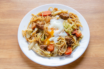 Pork Curry spaghetti  on wooden background ( Onsen tamago, Potato, enoki mushroom, onion, broccoli, Japanese style,)