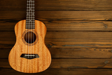Fototapeta premium Ukulele on wooden background