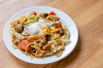 Pork Curry spaghetti  on wooden background ( Onsen tamago, Potato, enoki mushroom, onion, broccoli, Japanese style,)