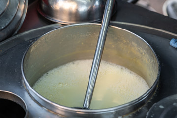 Close-up of Boiling soybean milk in big pot at the street food market, Thailand.