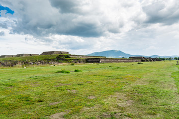 Obraz premium Ruins of the architecturally significant Mesoamerican pyramids and green grassland located at at Teotihuacan, an ancient Mesoamerican city located in a sub-valley of the Valley of Mexico