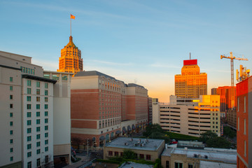 Fototapeta na wymiar San Antonio city skyline including Hotel Contessa, Westing Riverwalk, Drury Plaza Hotel and Tower Life Building at sunrise in downtown San Antonio, Texas, USA.