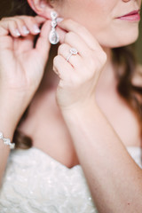 bride wedding morning putting on jewelry - 299129116
