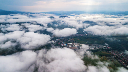 Aerial view through clouds to the city of Dolny Kubin