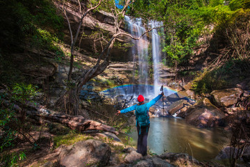 The girl in blue  sweater touring on Yung Thong waterfall, Beautiful waterfall in Udonthani province, ThaiLand.