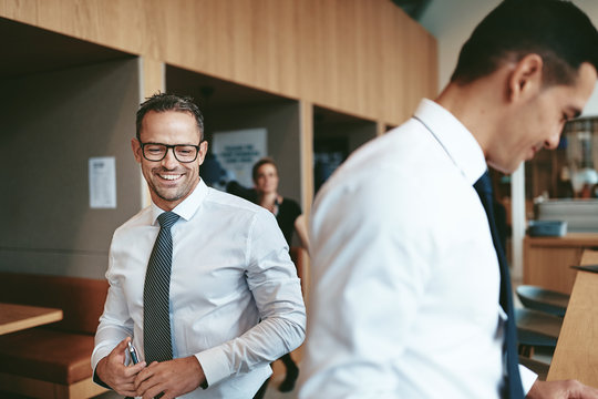 Smiling matue businessman working with colleagues in an office