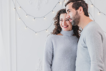 Cropped picture of smiling man and woman looking hopefully in the future during new year time.