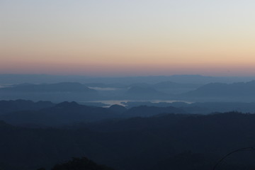 Beautiful Landscape of mountain layer in morning sun ray