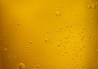 Bubbles on beer background. Oil drop shape on yellow background.Golden circle bubble water pattern.