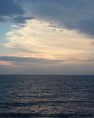 Naklejka na ściany i meble beautiful clouds at sunset over the sea