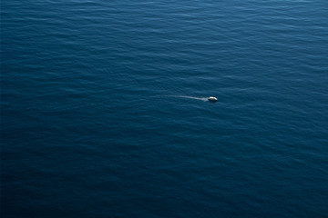 a small boat sailing in the sea