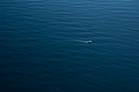 a small boat sailing in the sea © Maksim