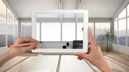 Hands holding and drawing on tablet showing modern white bedroom with bathtub details CAD sketch. Real finished interior in the background, architecture design presentation