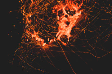 Fire flames with sparks in the dark background