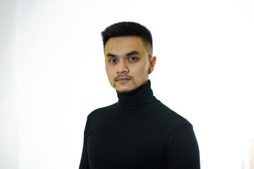 Portrait of a young asian guy on a white background. Studio shot