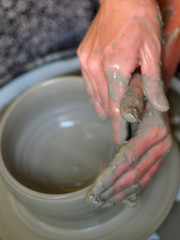 Making Ceramic Molds: Hands molding pottery. Mugs made of clay