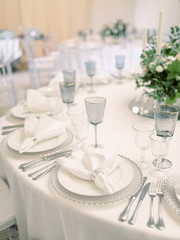 Table settings for a luxury wedding reception. Outdoor wedding