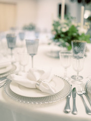 Table settings for a luxury wedding reception. Outdoor wedding