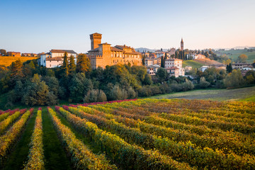 Fototapeta na wymiar Levizzano Rangone Castle, with vineyards, during autumn. Modena province, Emilia Romagna, Italy