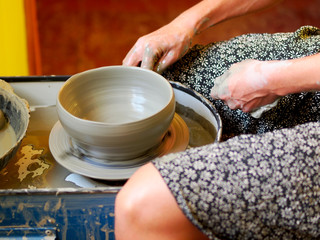 Making Ceramic Molds: Hands molding pottery. Mugs made of clay