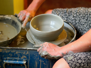 Making Ceramic Molds: Hands molding pottery. Mugs made of clay