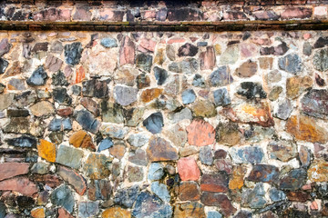 Old ancient stone wall in the sunlight in the daytime,suitable to use as a background, idea copy space.