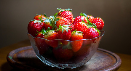 Strawberries in a glass bowl, forming a small pyramid for snack