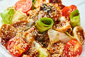 Tasty salad with smoked eel, avocado and tomato. Healthy food concept