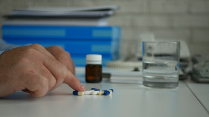 Image with Employee  Suffering a Big Headache Taking Medical Pills