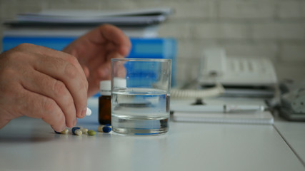 Image with Employee  Suffering a Big Headache Taking Medical Pills