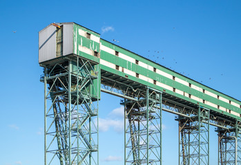 Grain elevator for grains, oil seeds and pulses at a port facility. Birds sitting on top of the structure. Port Terminal, Vancouver, BC, Canada