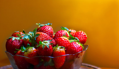 Strawberries in a glass bowl, forming a small pyramid for snack