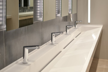 commercial bathroom, sink in a public toilet.