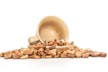 Lot of whole fresh brown bean vicia faba with ceramic cup isolated on white background