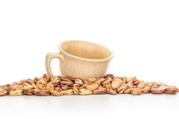 Lot of whole fresh brown bean vicia faba with ceramic cup isolated on white background