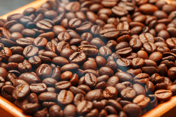 Fresh and aromatic roasted coffee beans in two wooden box, can be used as background.